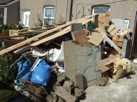 Bags and boxes separated for donation and recycling at a clearance site